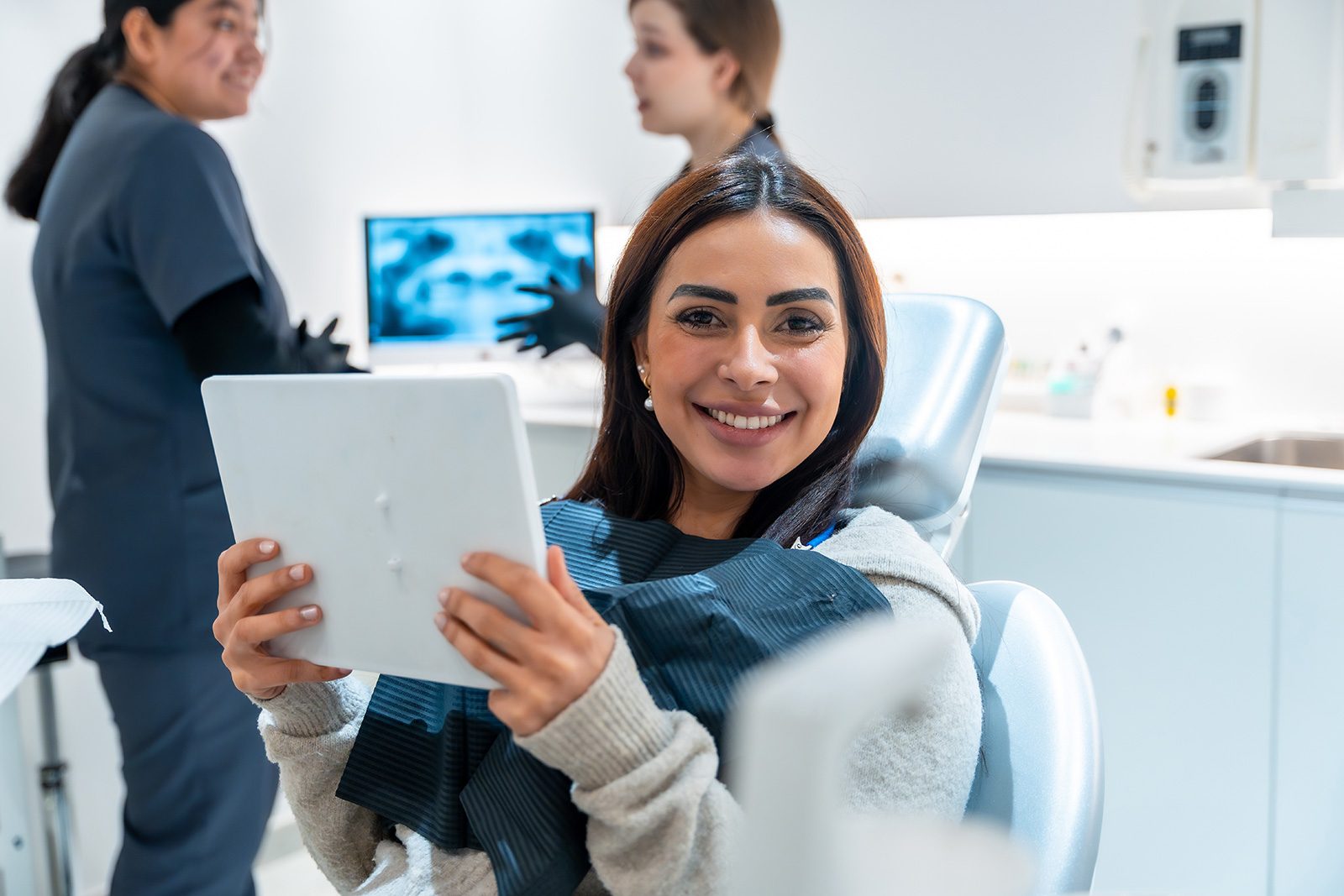 A patient smiling in the treatment chair